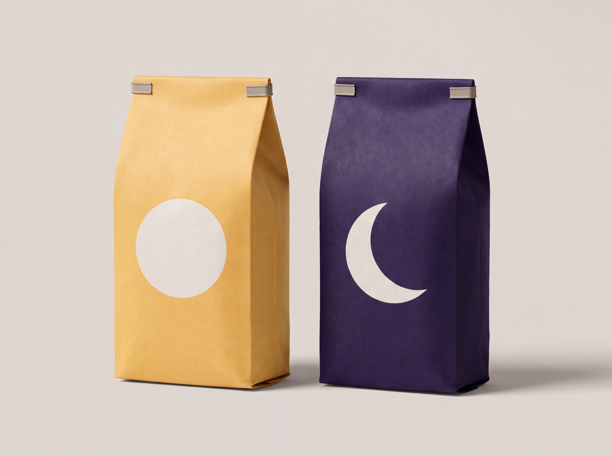 Two Wonder Bean coffee bags with tin ties: amber with the full moon, purple with the crescent
